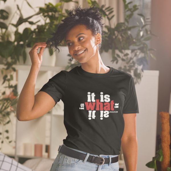 A woman standing in front of some plants wearing a t-shirt