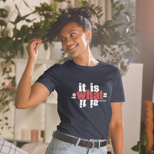 A woman standing in front of some plants wearing a t-shirt