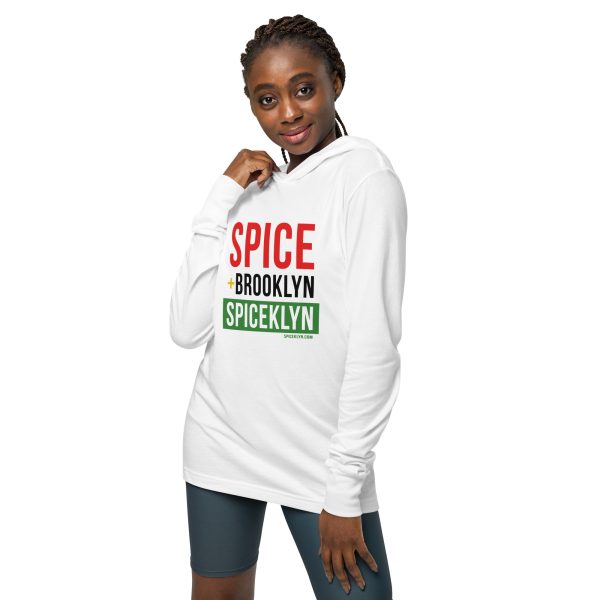 A woman wearing a white hoodie with the word spice in red and green.