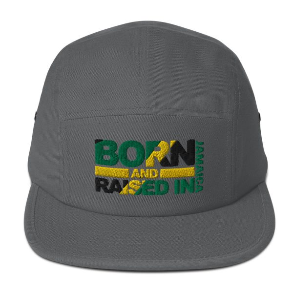 A gray hat with the words born and raised in jamaica.