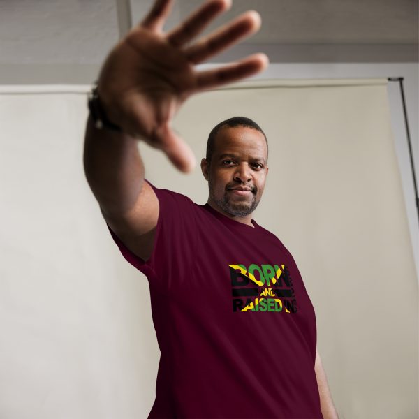 A man in maroon shirt raising his hand.