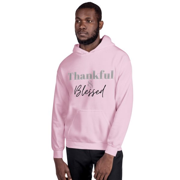 A man in a pink hoodie with the words " thankful blessed ".