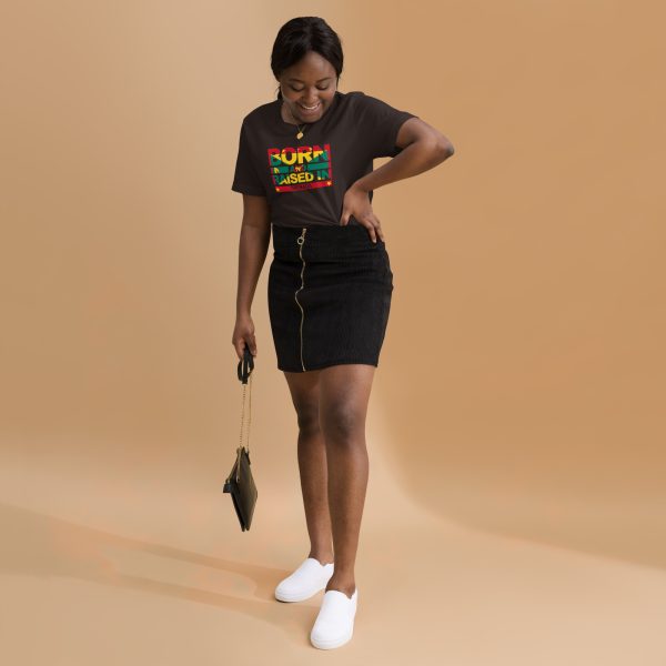 A woman standing in front of a brown background.