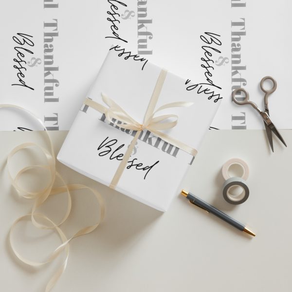 A gift wrapped in white paper with scissors and ribbon.